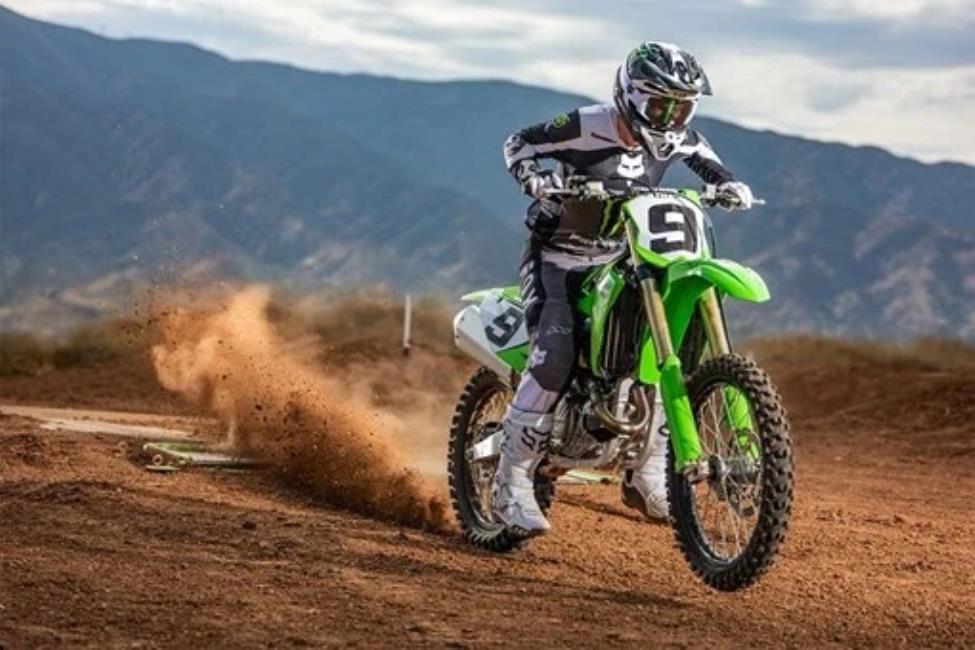 Kawasaki KX450 dirt bike landing a jump